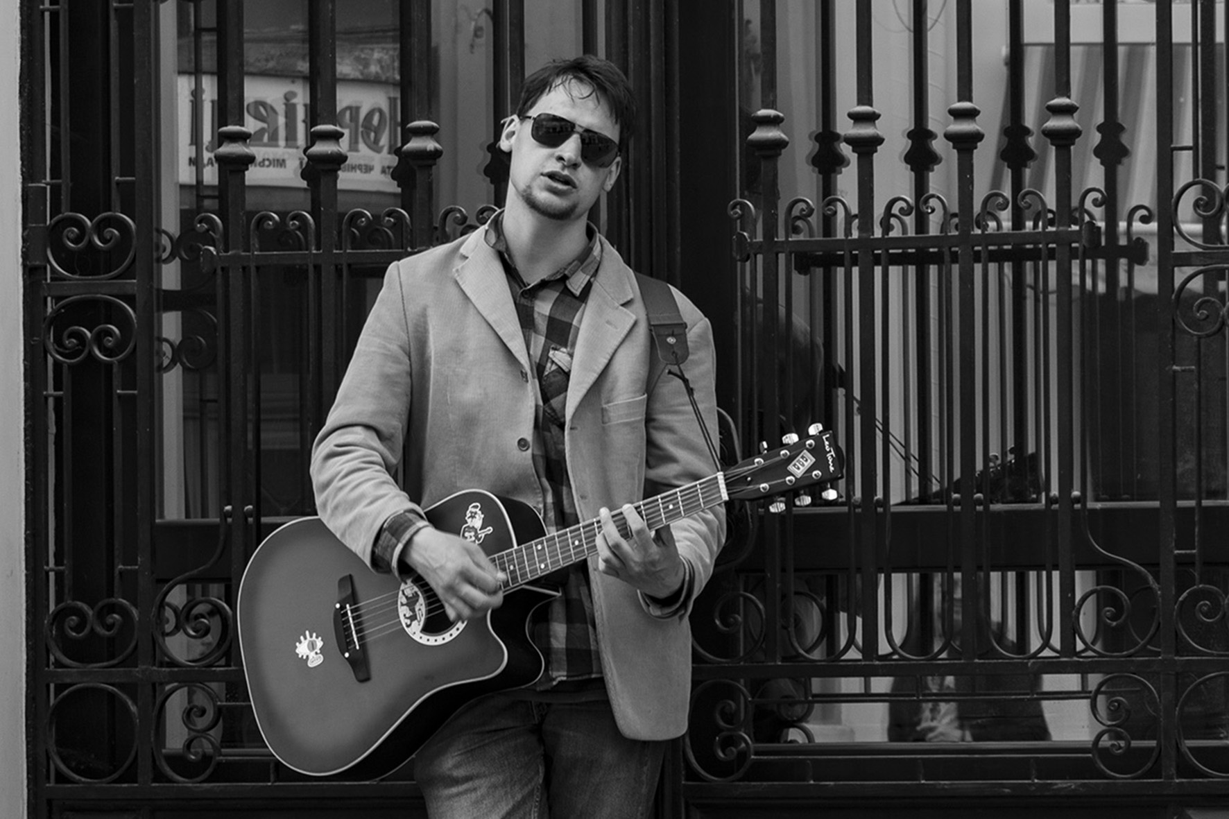 man playing guitar b&w photo